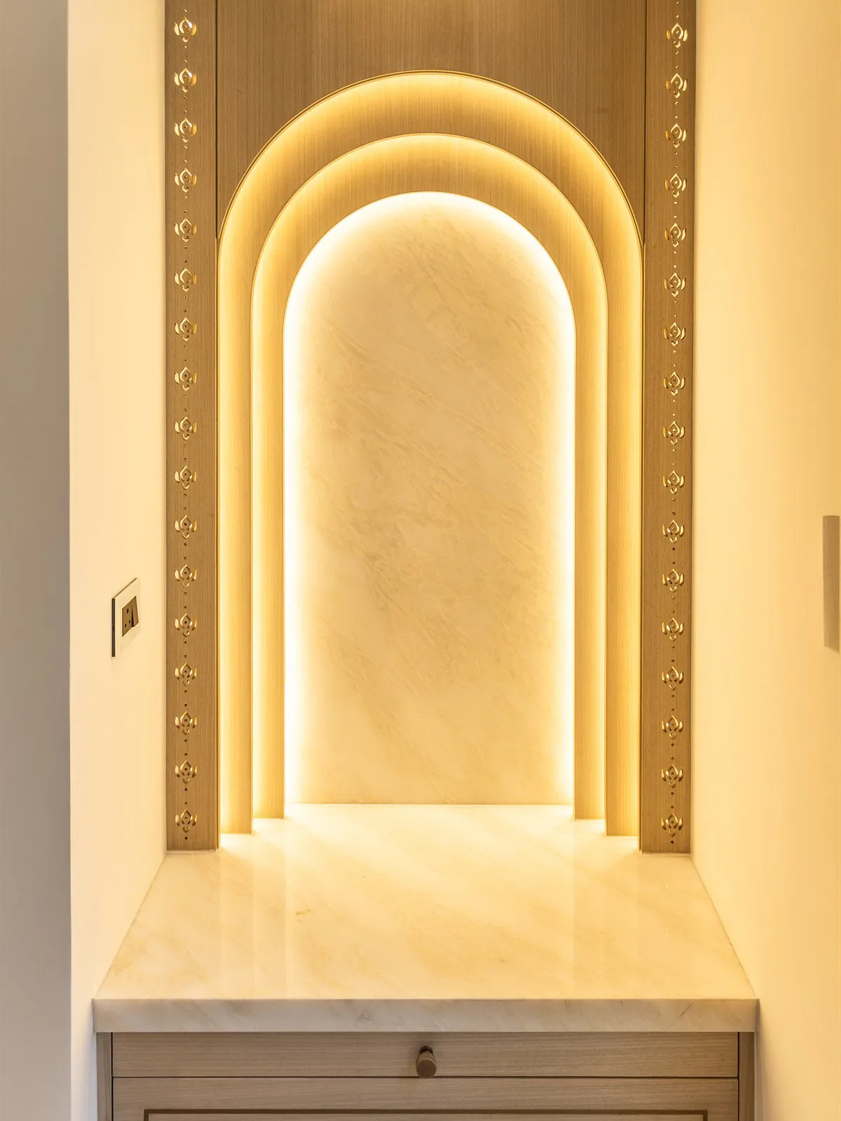 Backlit onyx prayer niche with brass inlay pilasters — Mr Mohak residence